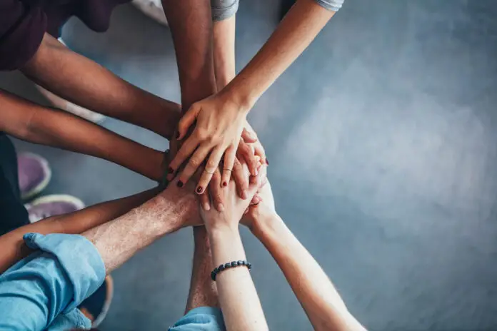 Stack of hands showing unity