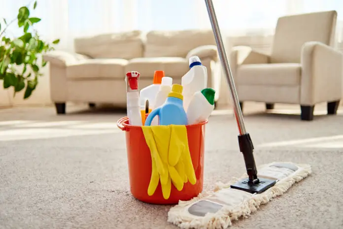 Cleaning set for different surfaces in orange bucket and mop on