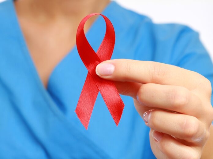 Nurse with aids ribbon, isolated on white background